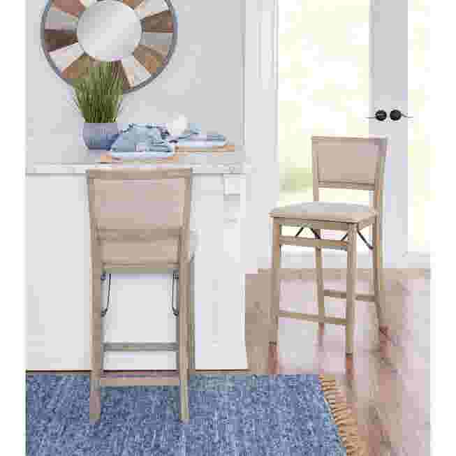 Two grey wash folding stools in a kitchen setting