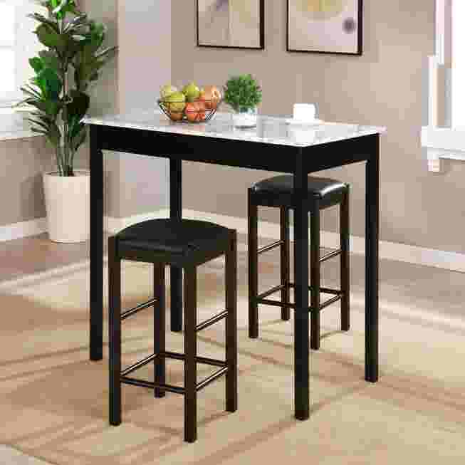 Black tavern set with faux marble top and two stools in a dining area.