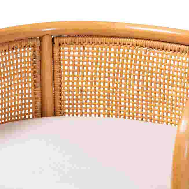 Close-up of white cushion and woven rattan back panel on counter stool