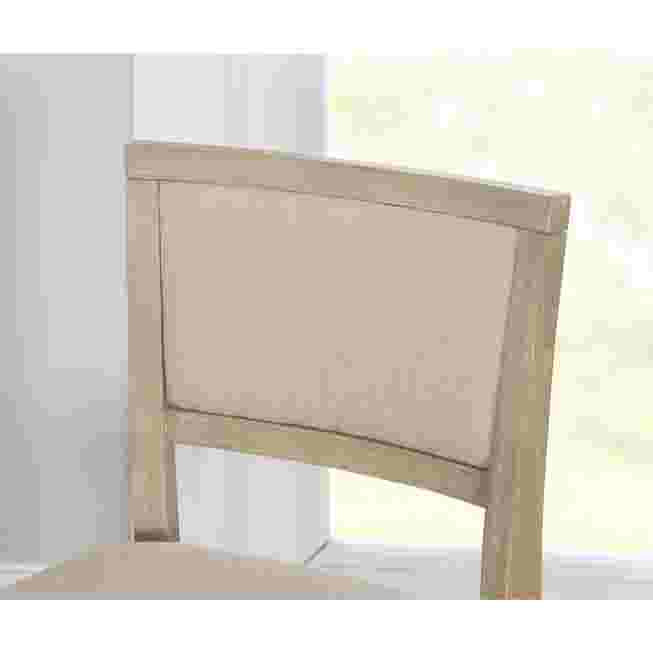 Close-up of the backrest of a grey wash folding stool