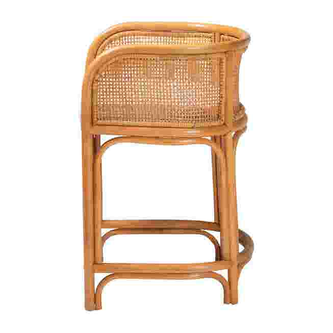 Side view of natural rattan counter stool with white cushion