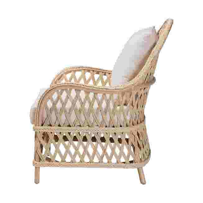 Side view of ivory braided rattan armchair with white cushion