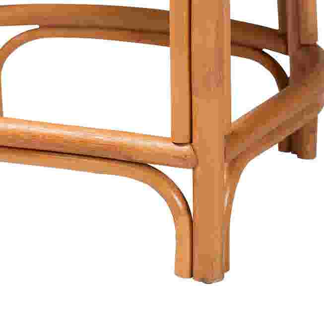 Close-up of rounded legs and footrest frame on natural rattan counter stool