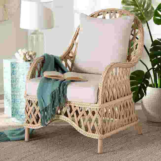 Ivory braided rattan armchair with white cushion in a living room setting