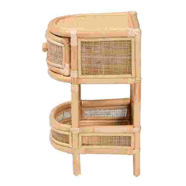 Side view of a natural rattan nightstand with a drawer and shelf.