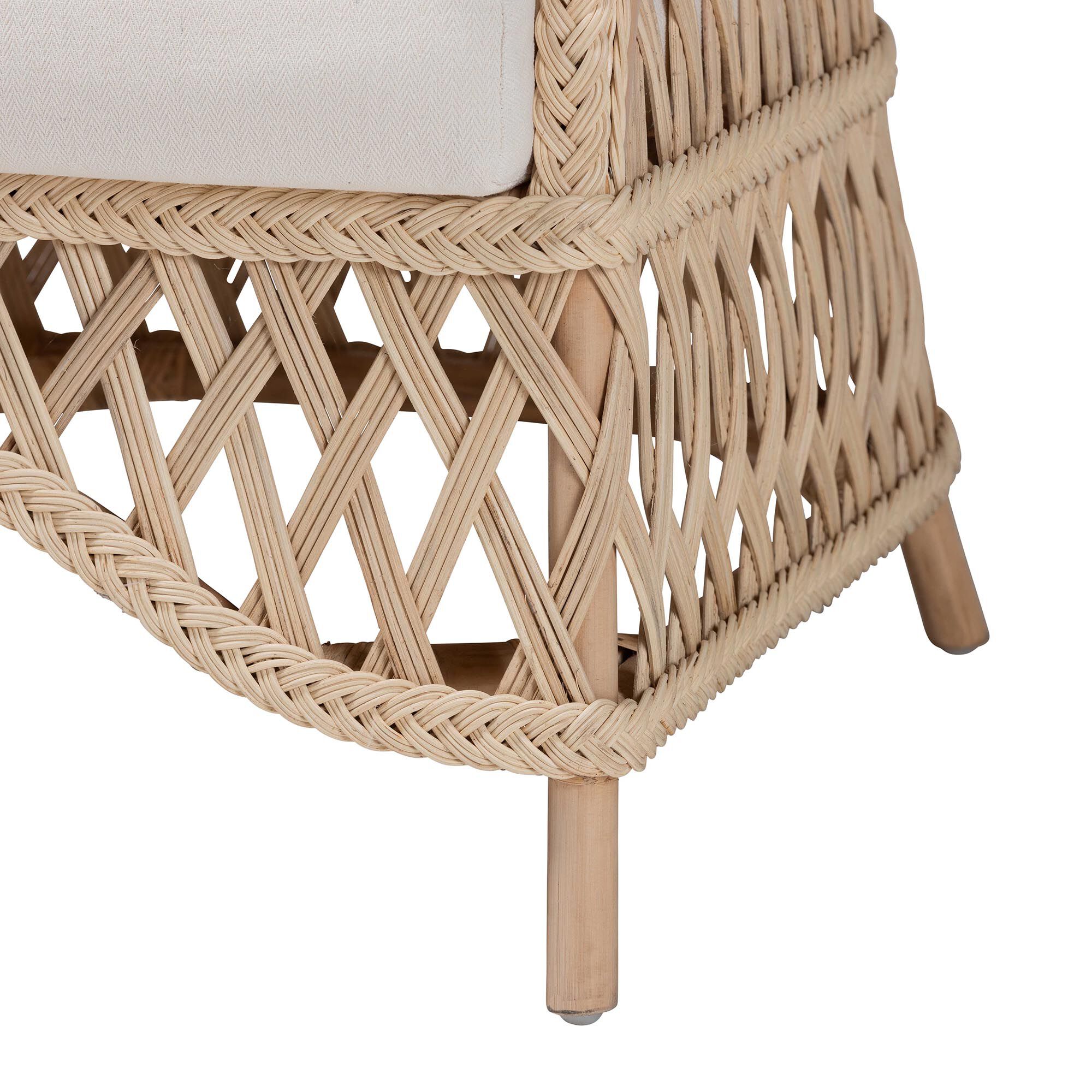 Close-up of the woven base and leg of ivory rattan armchair