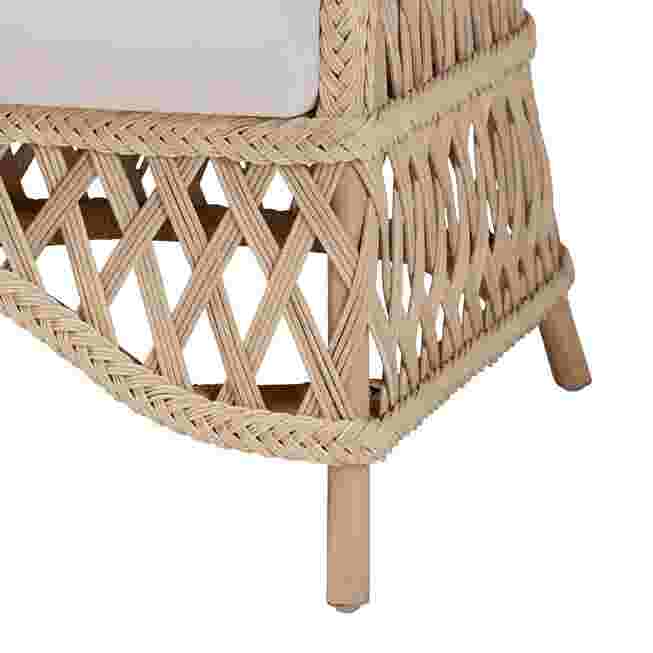 Close-up of the woven base and leg of ivory rattan armchair