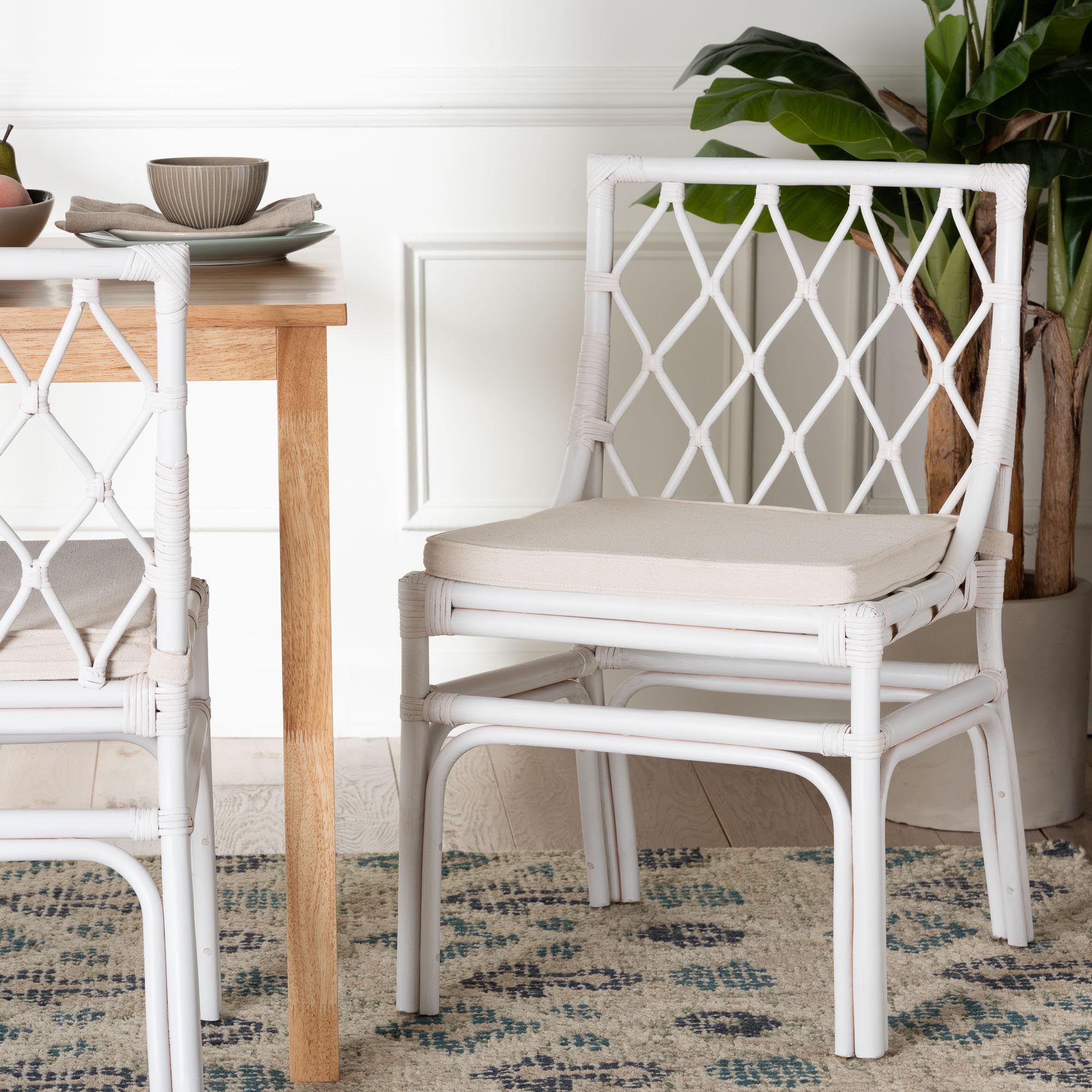 White rattan dining chair in a bohemian interior setting.